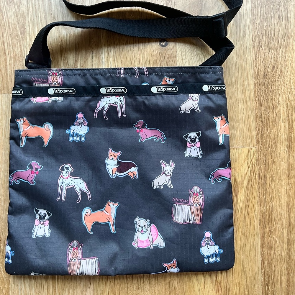 Authentic Le Sport Sac messenger bag. Black. Dogs print. Excellent condition!